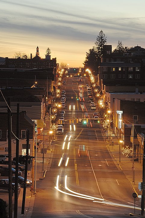 Auto insurance in Marion, VA vehicles driving at dusk down the street