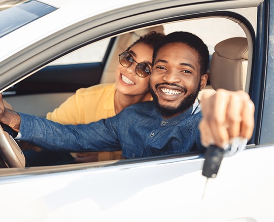 Auto insurance in Glade Spring, Wytheville, and Bristol, VA, showing happy couple in a parked car with a key