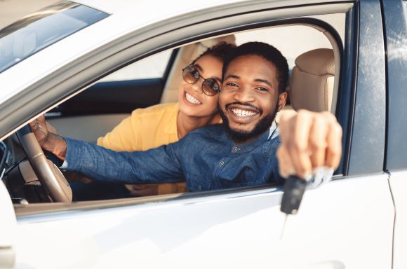 A Couple in Abingdon, VA Smiling After Getting Car Insurance for Their New Car