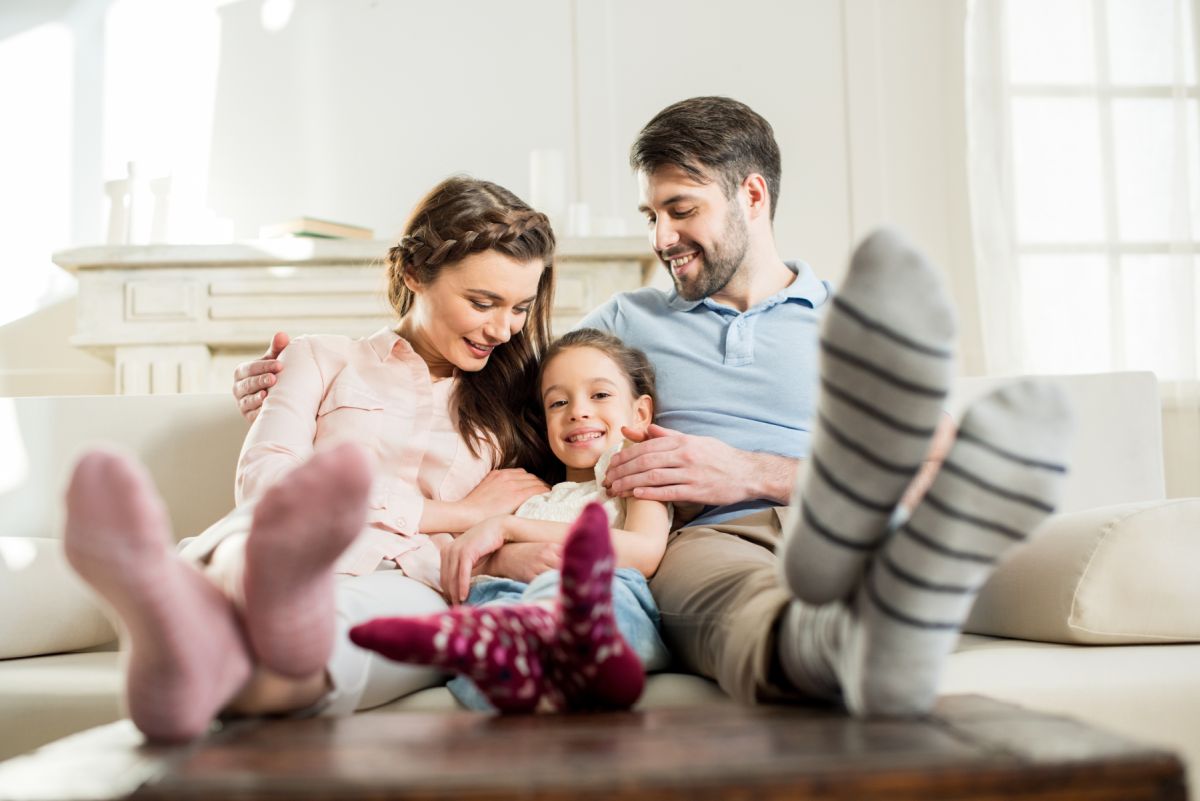 Family Sitting on Couch in Home with Affordable Home Insurance in Abingdon, VA 